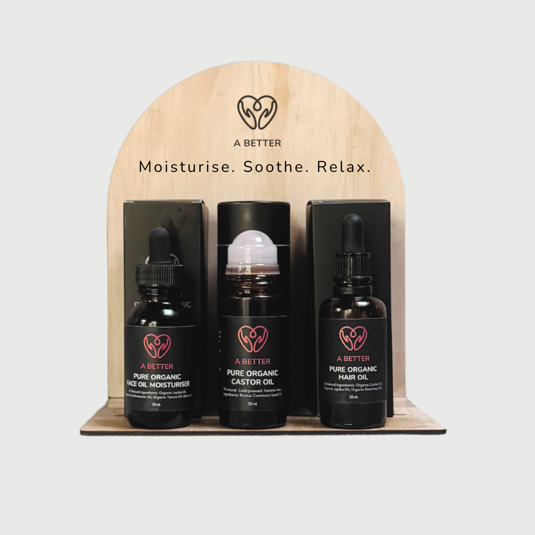 Three bottles of 'A Better' skincare products on a wooden stand with a light gray background.