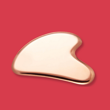 Pure Copper gourd-shaped guasha on a red background
