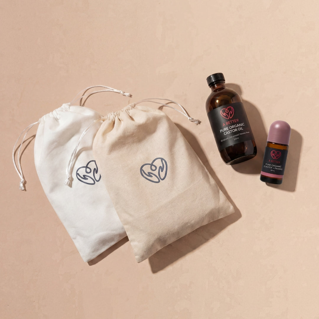 Two drawstring cotton bags with wraps, plus a castor oil bottle and castor oil roll on